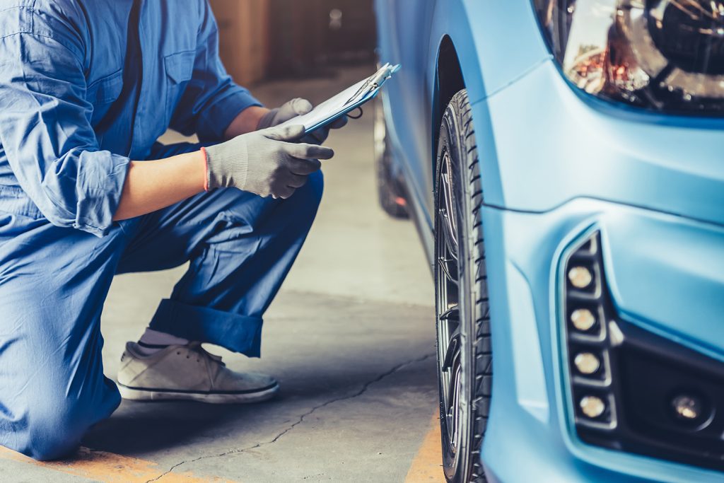 A mechanic holding a maintenance checklist.